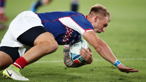 Kirill Golosnitskiy of Russia dives to score his side's first try during the Rugby World Cup.