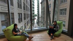 BOSTON, MA - JULY 18: Employees sit with a window view of old Boston behind Congress Street at the new headquarters of Boston catering service ezCater at 40 Water St. on July 18, 2019. The space features one twist on the typical tech office setup: The whole place is actually a WeWork. The coworking giant leased the space from building owner Related Beal, then rented it to ezCater for the next five years, part of a growing push by WeWork into more traditional corporate office leasing. WeWork has similar arrangements in other cities but this is the first of its kind to open in Boston. Its planning more. (Photo by David L. Ryan/The Boston Globe via Getty Images)