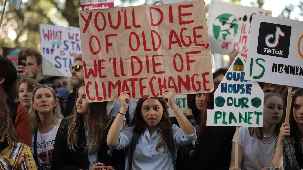 Children hold up placards as they attend the Global Climate Strike in London.