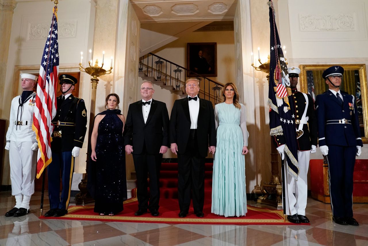 The President and first lady pose with Australian Prime Minister Scott Morrison and wife Jenny Morrison in the Grand Foyer of the White House.