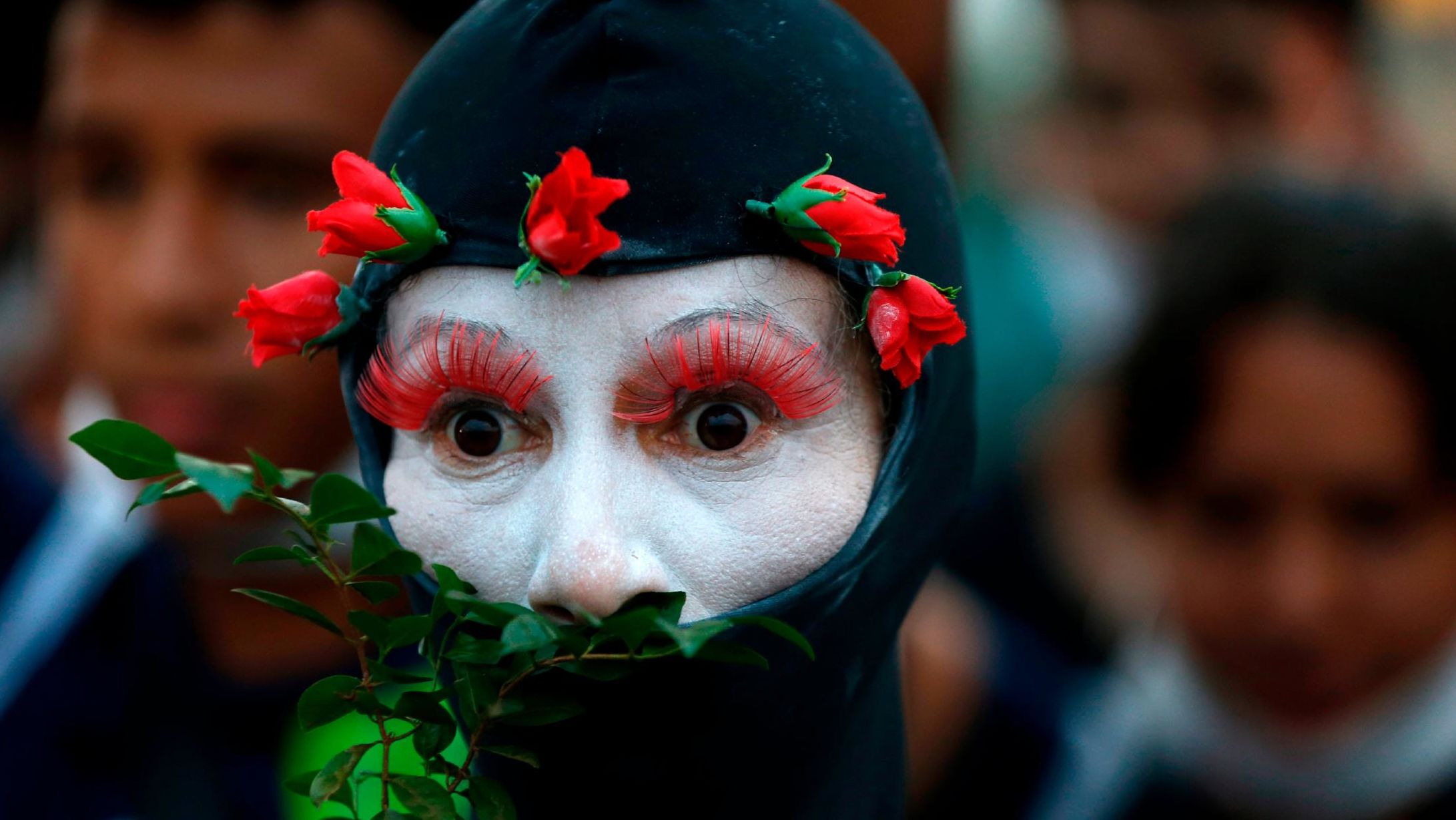 A demonstrator representing the Amazon rainforest performs during a protest in Brasilia, Brazil.