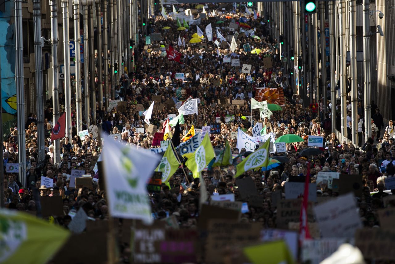Thousands crowd a street during a climate protest in Brussels.