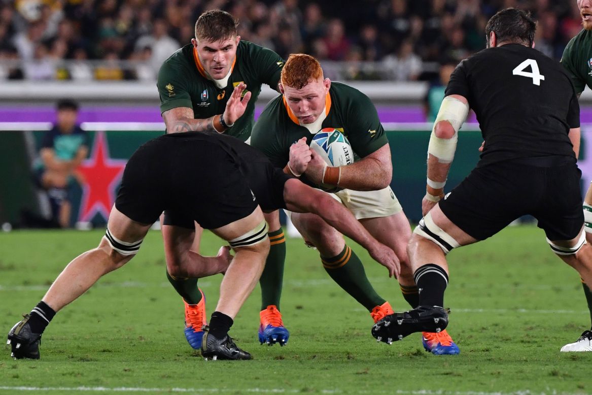 South Africa's prop Steven Kitshoff (C) is tackled. 
