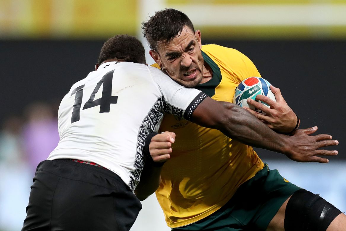 Also on Saturday, Australia beat Fiji 39-21. Adam Coleman of Australia is tackled by Josua Tuisova during their Group D game between Australia and Fiji at Sapporo Dome.