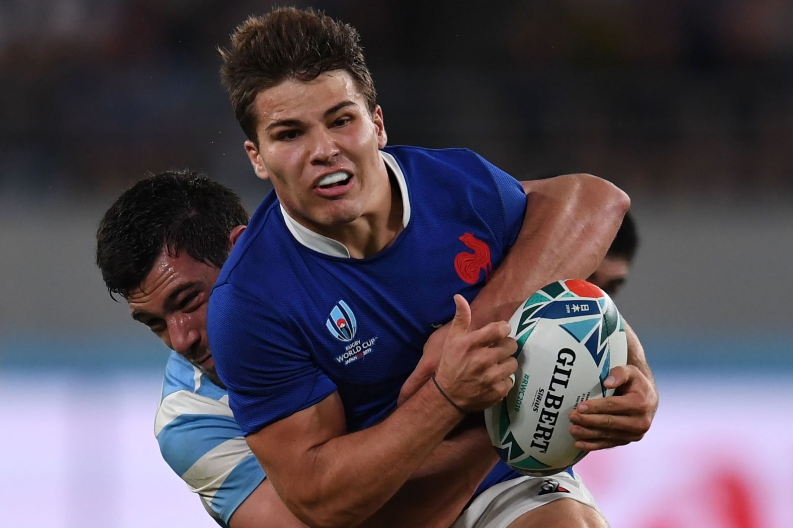 Argentina's lock Guido Petti Pagadizabal (L) tackles France's scrumhalf Antoine Dupont. France survived a remarkable second-half comeback from Argentina to record a thrilling 23-21 win.