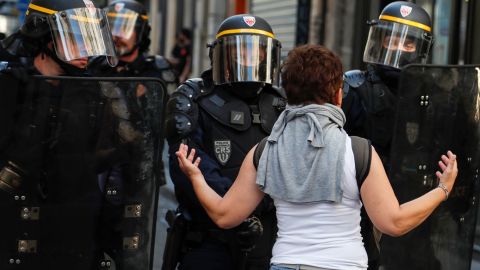 A woman speaks to riot policemen during an anti-government demonstration in Paris in September 2019.