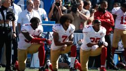 Colin Kaepernick, middle, and members of the San Francisco 49ers kneel during the national anthem prior to the game against the Seattle Seahawks at CenturyLink Field on September 25, 2016.