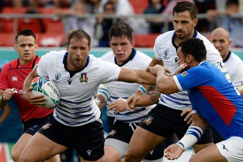 Italy's centre Tommaso Benvenuti fends off a tackle during the Japan 2019 Rugby World Cup Pool B match between Italy and Namibia.