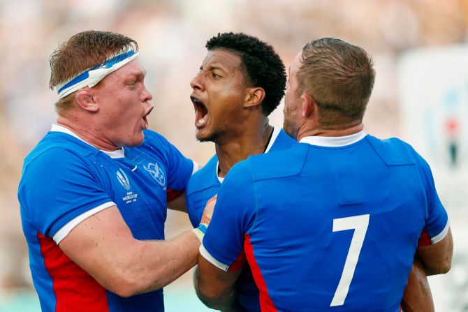 Namibia's Chad Plato celebrates with teammates after scoring a try against Italy. However, it would only prove to be a consolation.