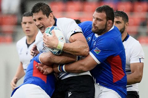Italy's lock Alessandro Zanni is tackled during his side's comfortable win in its opening game. 