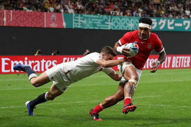 Sonatane Takulua is tackled by England's George Ford in the Group C game.