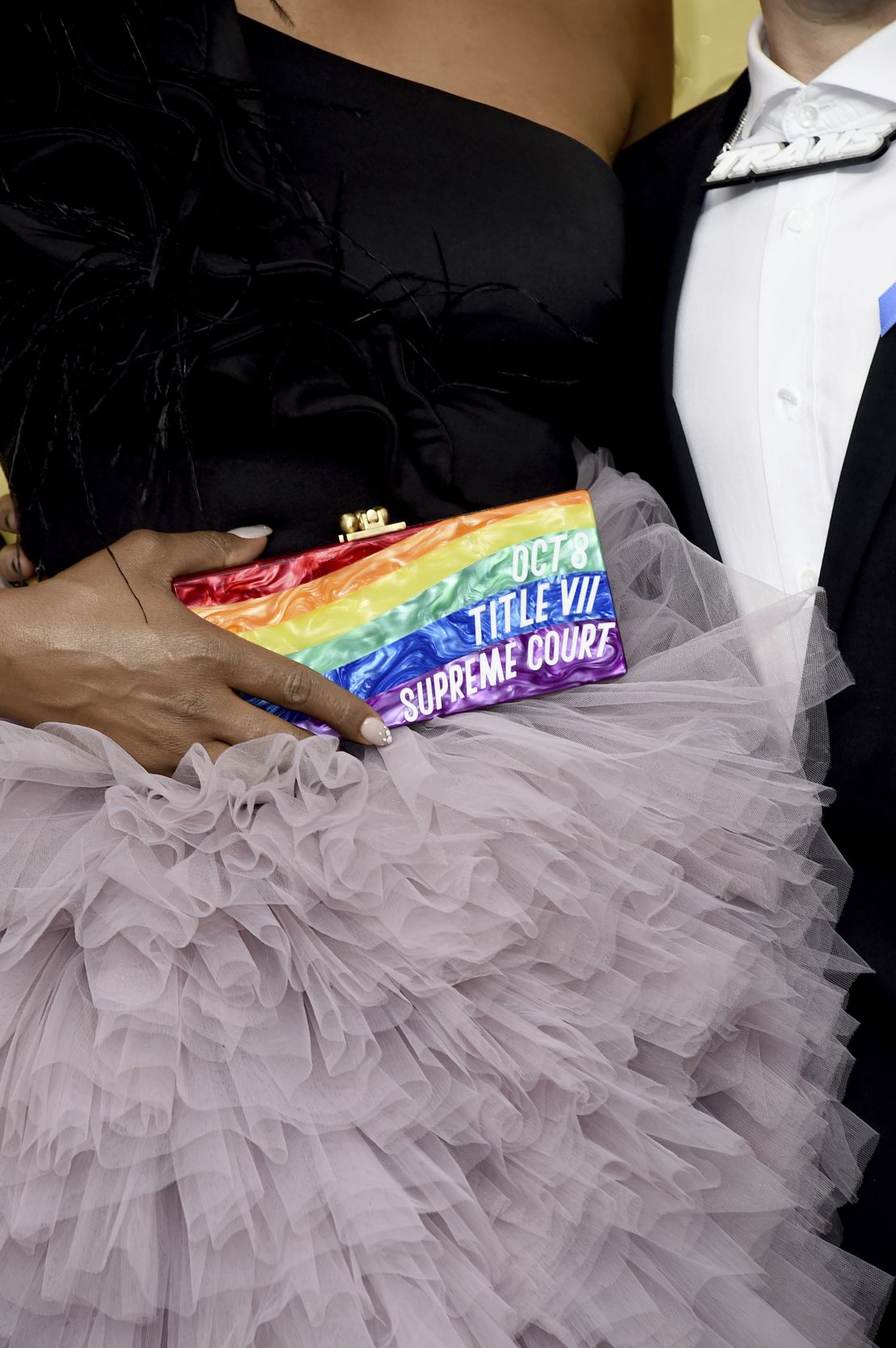 Laverne Cox carries a clutch bag calling attention to an upcoming Supreme Court ruling as she walks the red carpet at the Emmys.