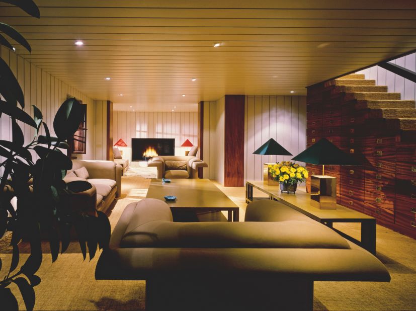 Fashion designer Giorgio Armani designed the living room in his home in Forte dei Marmi on the Versilia coast of Tuscany. It features clean lines, wood paneling, a graduated set of drawers built into the stairway, a long lacquered table and brass lamps.