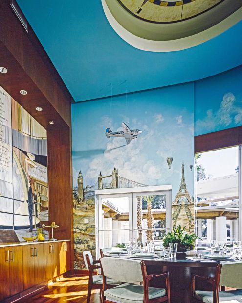 The airplane-obsessed actor John Travolta put his hobby front and center in his family's Florida home, covering the dining room with an aviation mural by Sandra Hillard. 