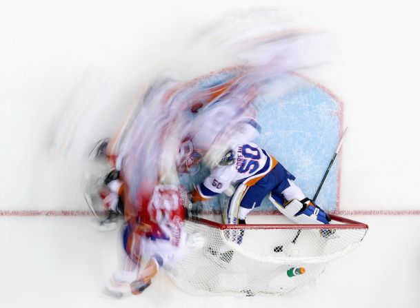 Jared Coreau of the New York Islanders makes a save against the New Jersey Devils during the third period of an NHL preseason game at the Prudential Center in Newark, New Jersey, on Saturday, September 21. The Devils defeated the Islanders 4-3.