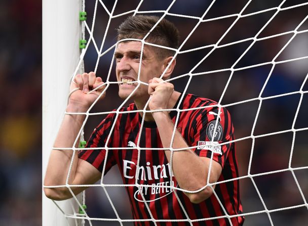 AC Milan's Krzysztof Piatek bites the net after missing a goal opportunity during the Italian Serie A football match against Inter Milan on September 21 in Milan.