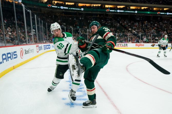 Dallas Stars' Taylor Fedun checks Minnesota Wild's Mats Zuccarello during the Stars' second preseason game at Xcel Energy Center in St. Paul, Minnesota, on Tuesday September 17. Dallas won 2-1.