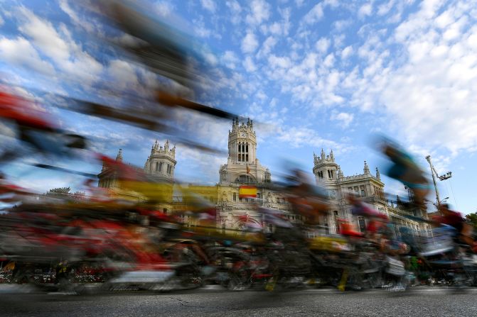 Cyclists ride past Madrid Town Hall during Stage 21 of the Tour of Spain 2019 on September 15 in Madrid.