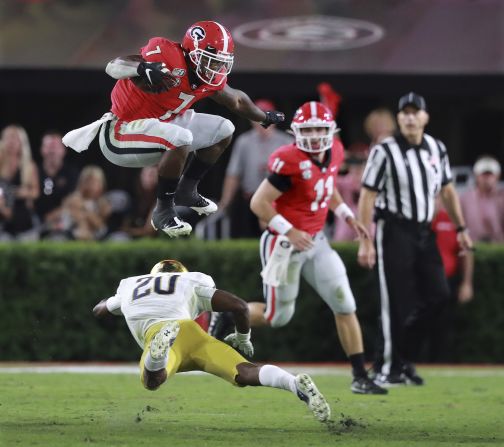 Georgia's D'Andre Swift leaps over Notre Dame cornerback Shaun Crawford for a first down in Athens, Georgia, on September 21. The Bulldog win marked the second time in three seasons Georgia has beaten Notre Dame.
