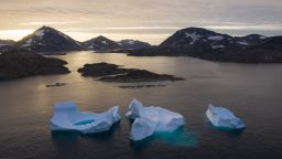 In this Aug. 16, 2019, photo, large Icebergs float away as the sun rises near Kulusuk, Greenland. Scientists are hard at work, trying to understand the alarmingly rapid melting of the ice. (AP Photo/Felipe Dana)