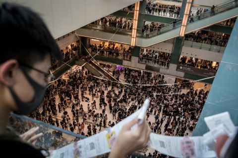 Pro-democracy protesters sing songs and chant slogans during a rally inside a shopping mall on September 22.