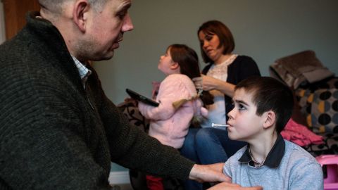 Alfie takes his cannabis oil medicine in front of his father, at their home on January 13, 2019 in Kenilworth, England.