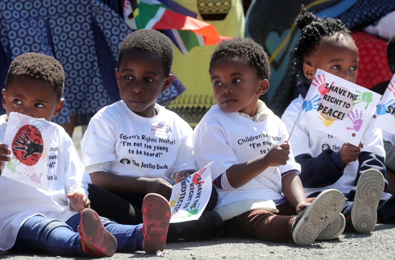 Children in Cape Town greet the royals.