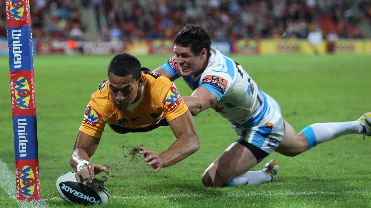 Folau of the Broncos scores a try in the NRL.