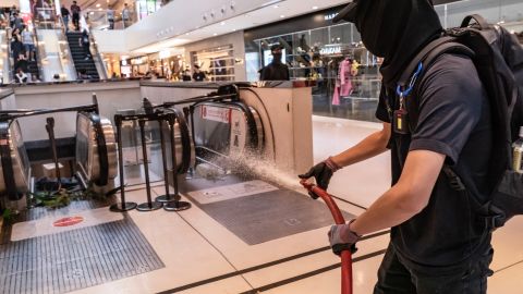 A protester uses a fire hose during a demonstration inside a shopping mall in Shatin district on September 22, 2019 in Hong Kong.