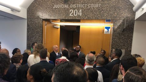 Onlookers were turned away from the courtroom after it reached capacity. 