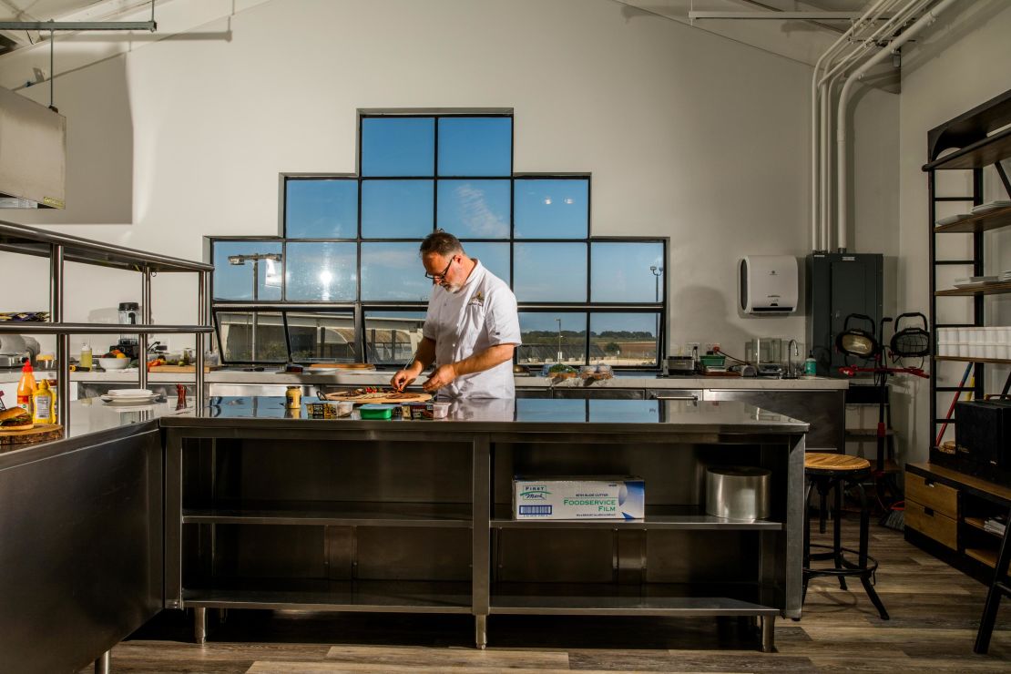 Tucker Bunch, culinary innovation and development chef at Sweet Earth, prepares food in the office's test kitchen.