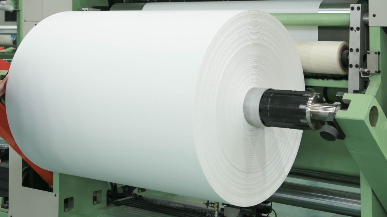 The limestone waste is ground into powder, mixed with resin, turned into small pellets and fed through large rollers.