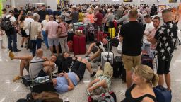 Passengers of British travel group Thomas Cook queue at Son Sant Joan airport in Palma de Mallorca on September 23, 2019. - British travel group Thomas Cook declared bankruptcy on September 23, 2019 after failing to reach a last-ditch rescue deal, triggering the UK's biggest repatriation since World War II to bring back stranded passengers. The 178-year-old operator had been desperately seeking £200 million ($250 million, 227 million euros) from private investors to save it from collapse. (Photo by JAIME REINA / AFP)        (Photo credit should read JAIME REINA/AFP/Getty Images)