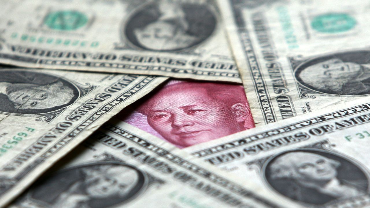 BEIJING, CHINA - MAY 15: (CHINA OUT) Dollars and yuan notes are seen at a bank on May 15, 2006 in Beijing, China. China's official exchange rate rose today to 7.9982 yuan per U.S. dollar, its highest level since a revaluation in last July, the government said. (Photo by China Photos/Getty Images)