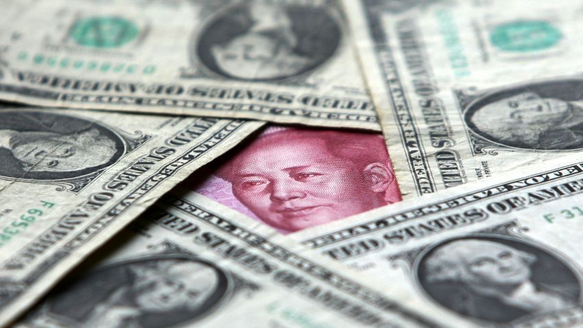 BEIJING, CHINA - MAY 15:  (CHINA OUT) Dollars and yuan notes are seen at a bank on May 15, 2006 in Beijing, China. China's official exchange rate rose today to 7.9982 yuan per U.S. dollar, its highest level since a revaluation in last July, the government said. (Photo by China Photos/Getty Images)