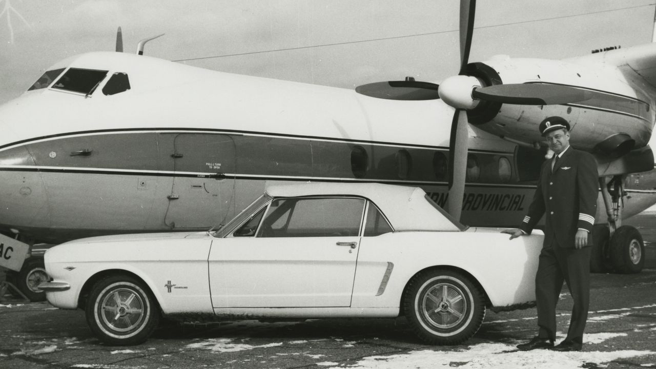 Tucker stands next to the car in 1966.