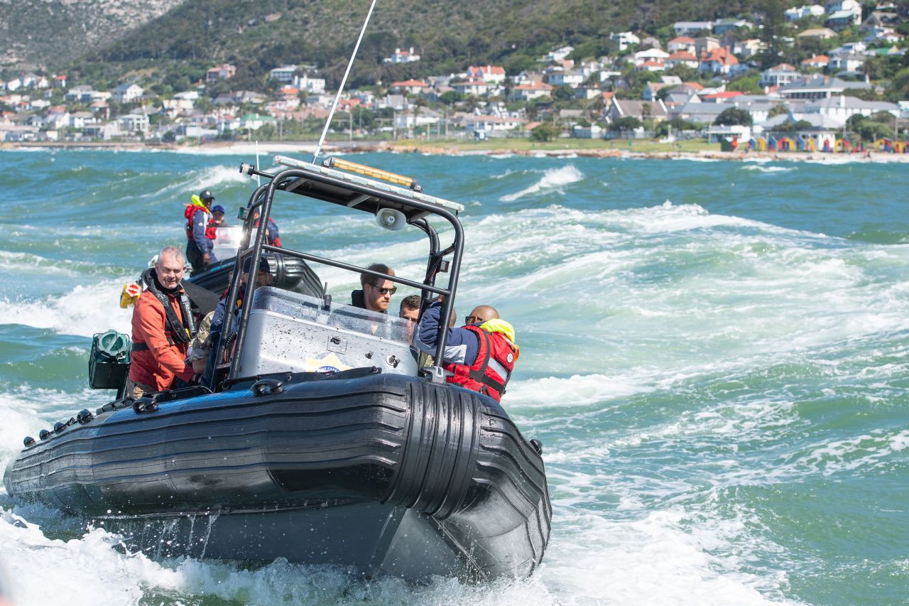 Prince Harry travels with a South African Maritime Police unit during a visit to Kalk Bay Harbour in Cape Town. The boat traveled to Seal Island, an abalone poaching hot spot.