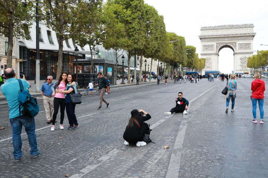 <strong>Avenue des Champs-Élysées: </strong>Tourists take pictures with the famed Arc de Triomphe in the background.