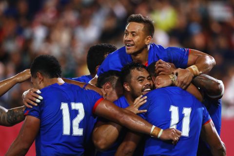 Ed Fidow celebrates with his Samoan team mates after scoring his sides third try during its win over Russia. 