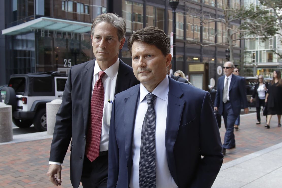 Devin Sloane, right, arrives at federal court for sentencing in a nationwide college admissions bribery scandal, Tuesday, Sept. 24, 2019, in Boston.