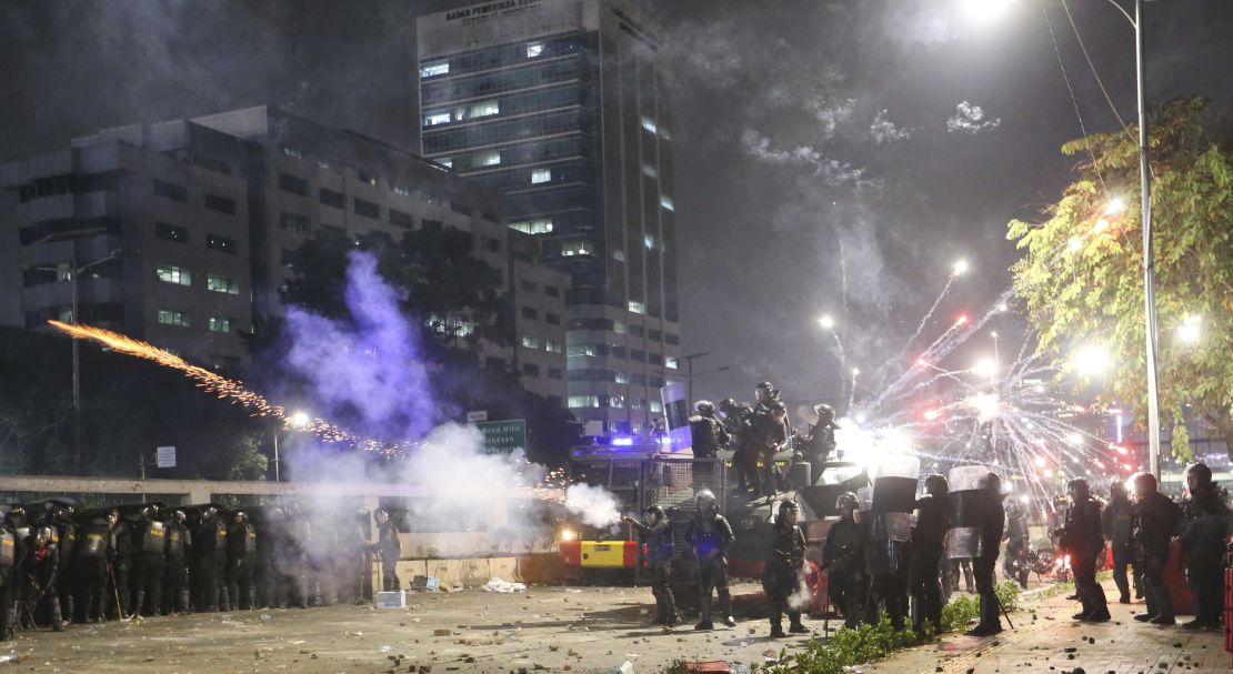 Indonesian riot police fire tear gas to disperse student protesters during a clash outside parliament in Jakarta, Indonesia, on September 24, 2019. 