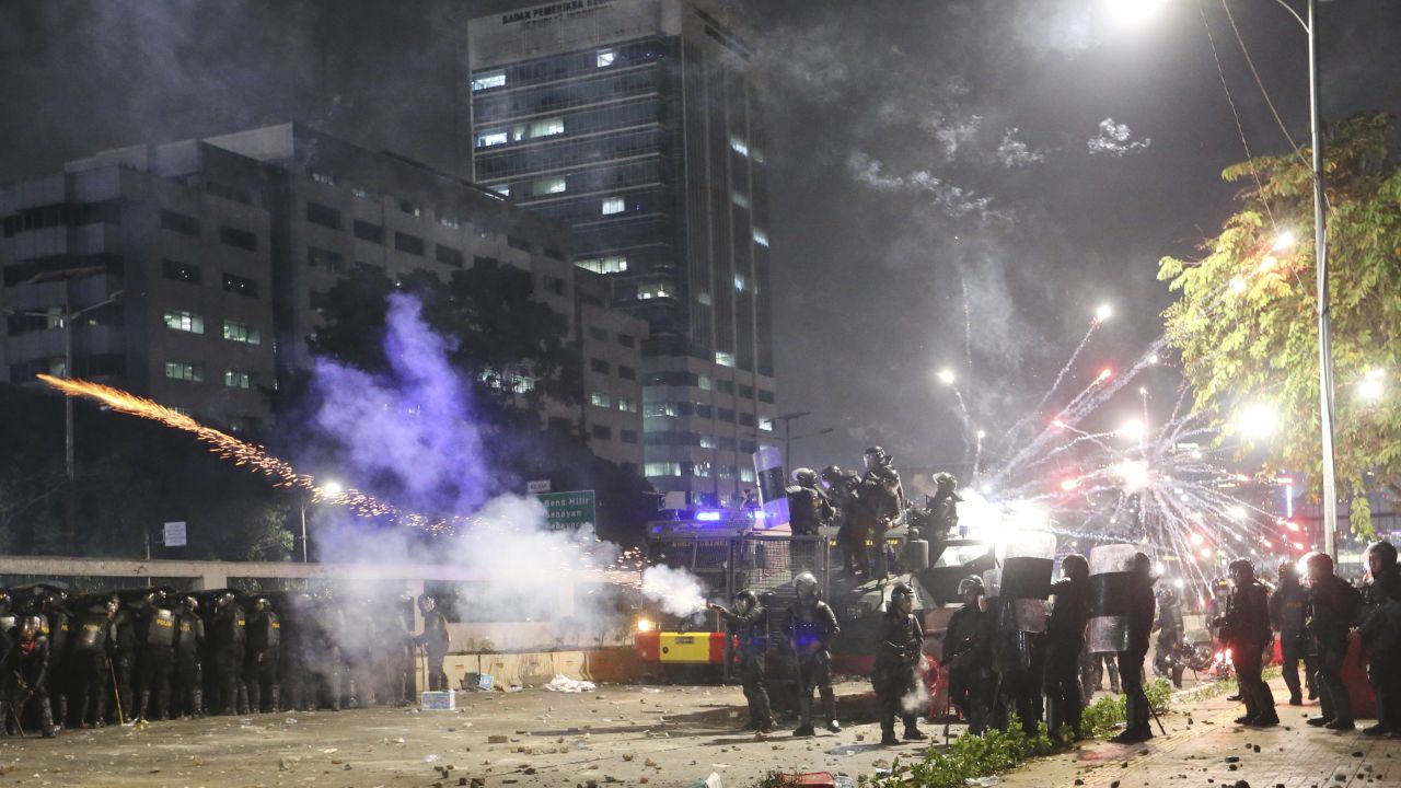 Indonesian riot police fire tear gas to disperse student protesters during a clash outside parliament in Jakarta, Indonesia, on September 24, 2019.
