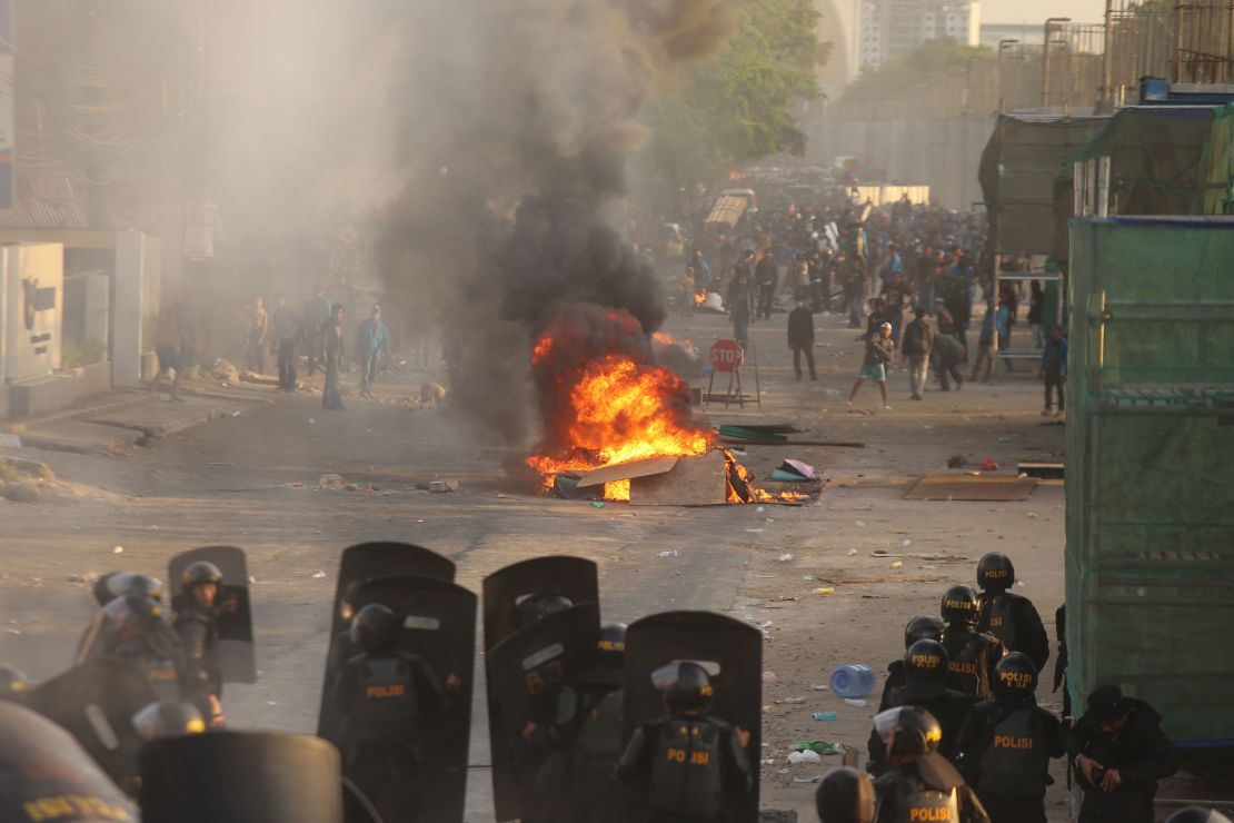 Riot police face off with protesters in Makassar, Sulawesi on September 24, 2019, as demonstrations in Jakarta and other cities take place for a second day in a row against the government's proposed change to its criminal code laws. 