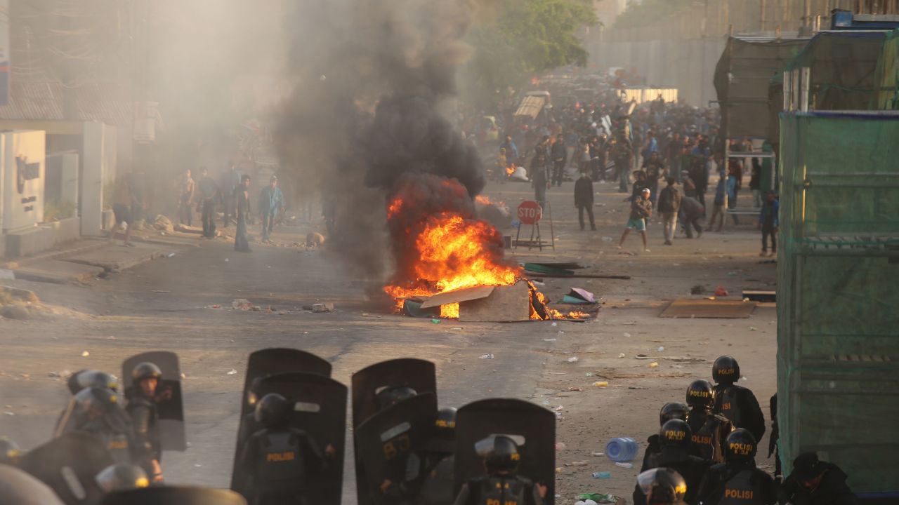 Riot police face off with protesters in Makassar, Sulawesi on September 24, 2019, as demonstrations in Jakarta and other cities take place for a second day in a row against the government's proposed change to its criminal code laws.