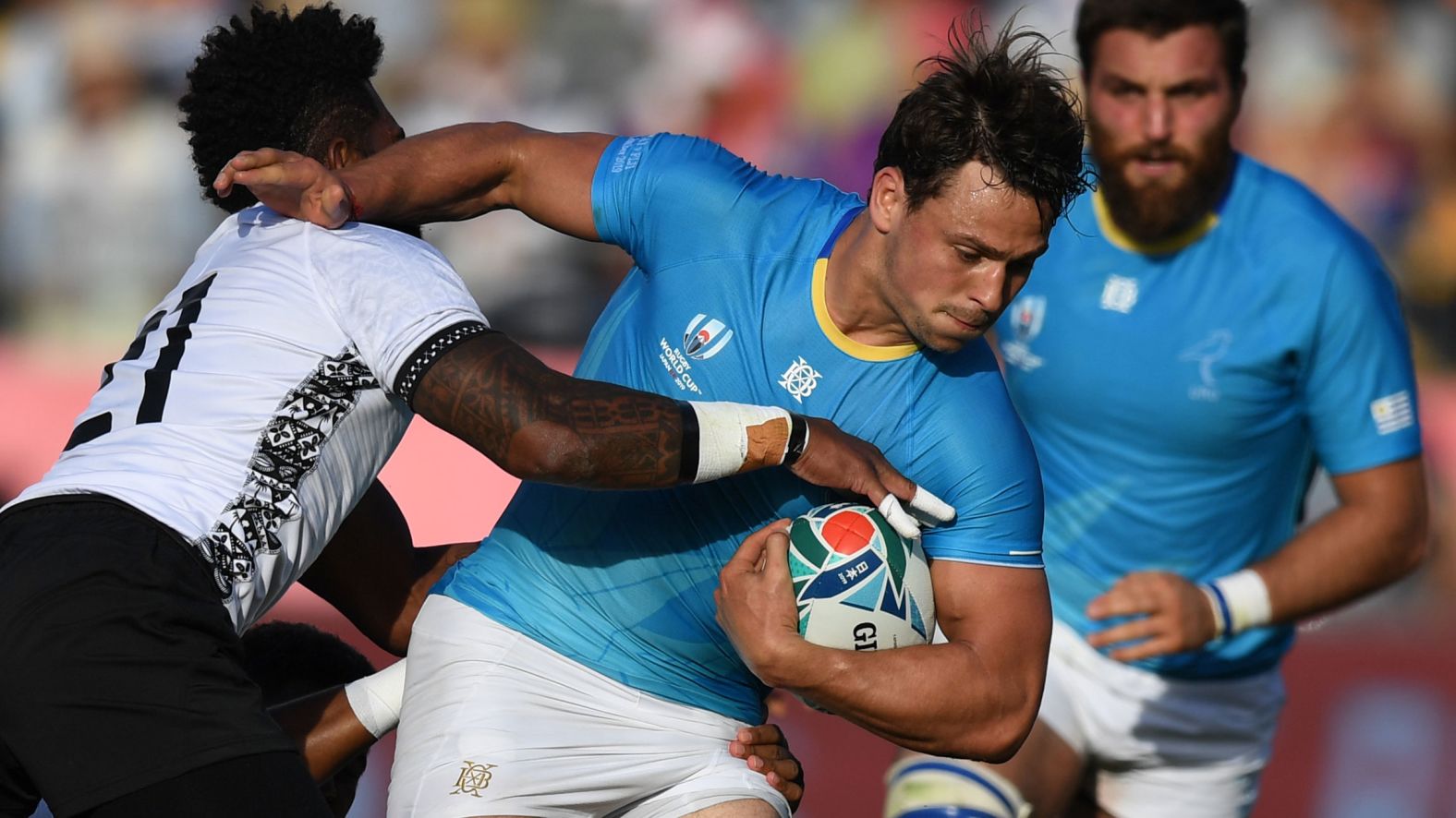 Uruguay's wing Nicolas Freitas is tackled by Fiji's scrum-half Nikola Matawalu during the Pool D match.