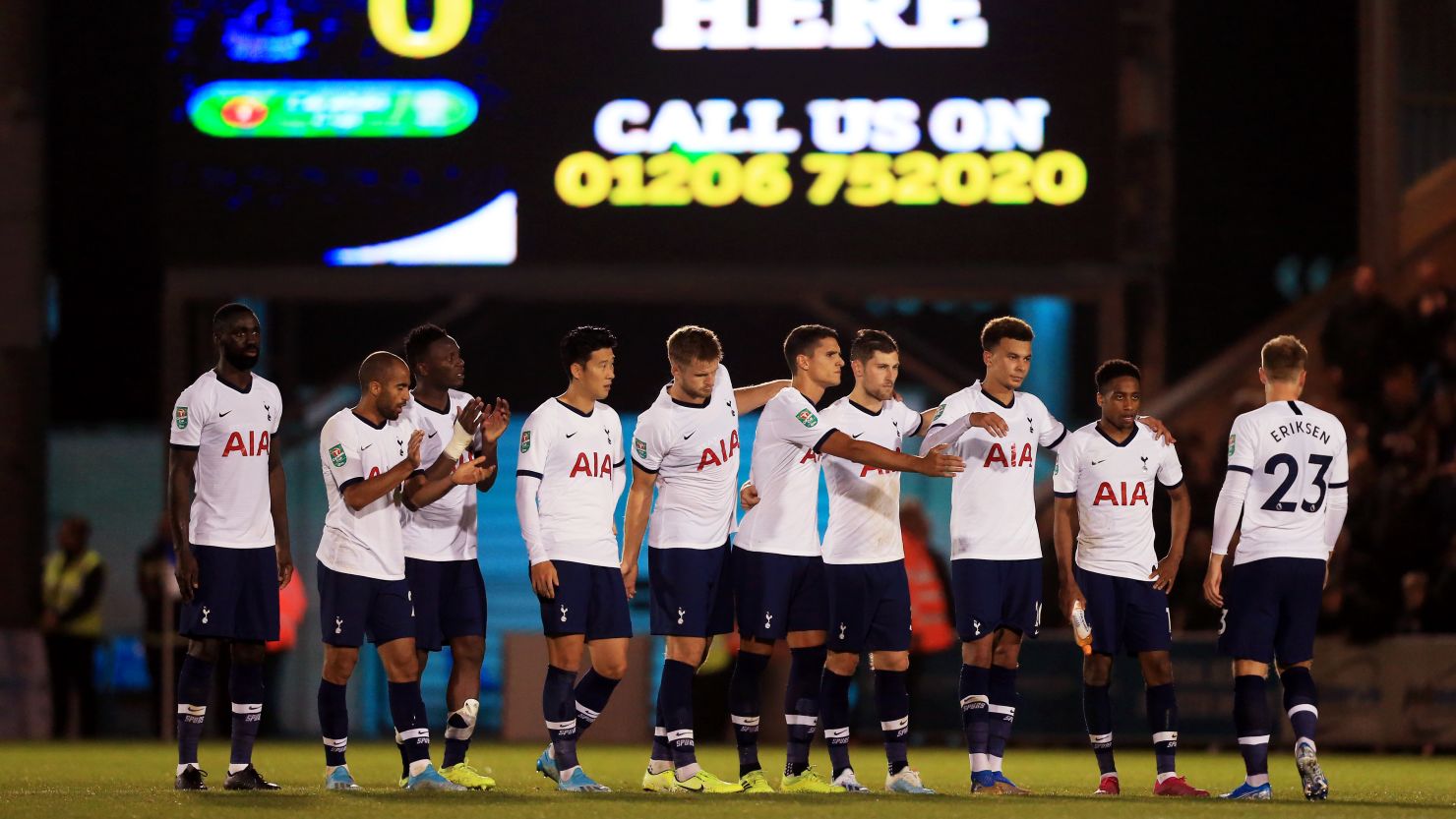 Tottenham players console Christian Eriksen after his missed penalty against Colchester.