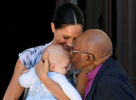 Tutu kisses Archie, the son of Britain's Prince Harry and Meghan, the Duchess of Sussex, in September 2019. The royal family was visiting South Africa.
