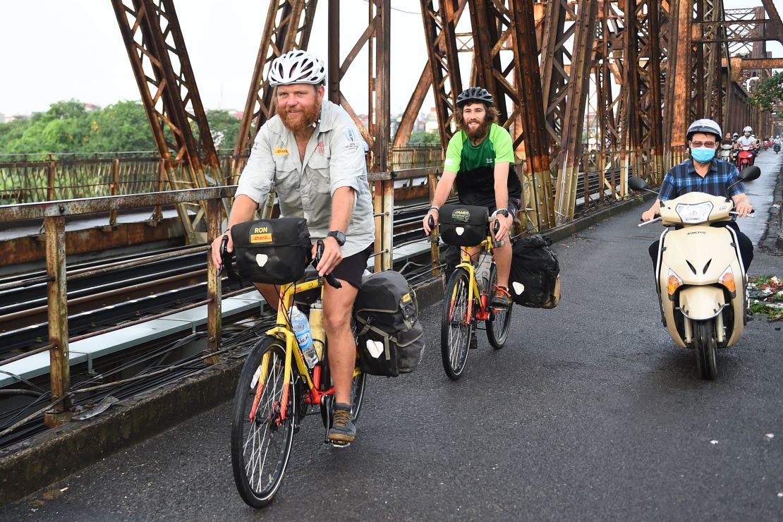 Rutland and Owens cycle on the Long Bien Bridge in Hanoi.