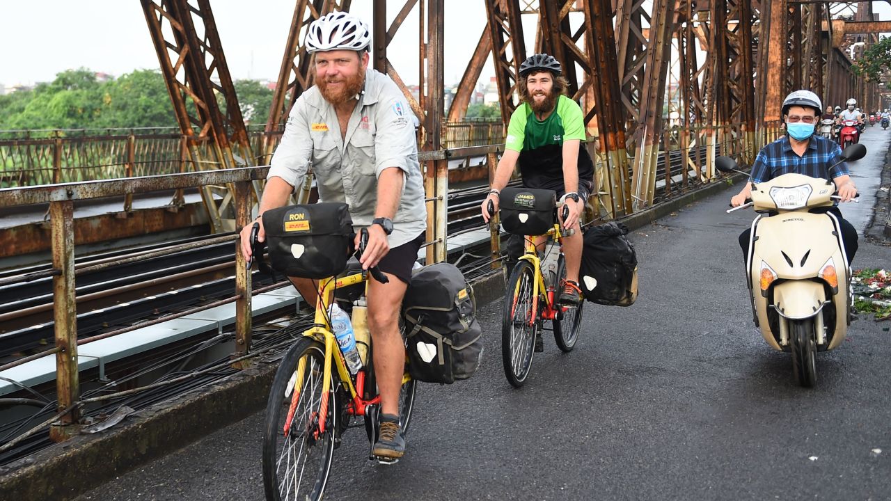 Rutland and Owens cycle on the Long Bien Bridge in Hanoi.