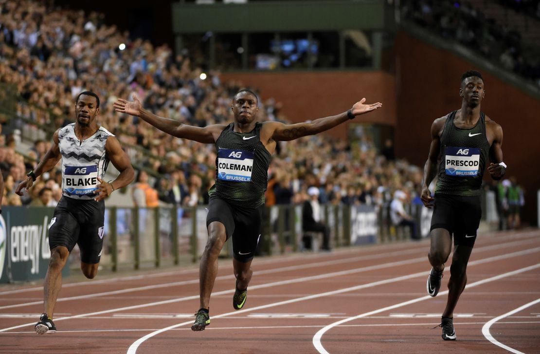 Coleman raises his arms in celebration after winning the men's 100m final of the Memorial Van Damme athletics event.